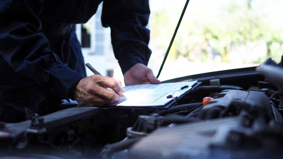 A lending rep inspecting a vehicle.