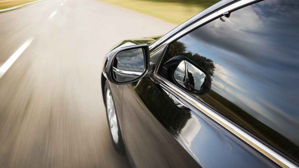 A car with considerable equity driving on the freeway.