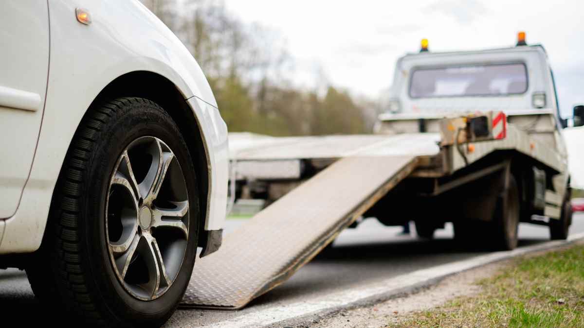 A car being towed by a tow truck after being repossessed